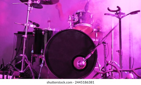 Outdoor drum kit including drumsticks, snare drum, bass drum and cymbals. Drum kit in smoke on an outdoor stage - Powered by Shutterstock