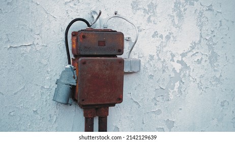 Outdoor Electric Fuse Box With Power Outlets With Rusty Metal Enclosure Mounted On Old Building Wall