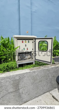 Outdoor Electrical Control Panel with Open Door Enclosed by Greenery