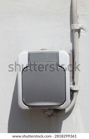 Outdoor electrical socket hole on concrete wall