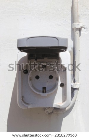 Outdoor electrical socket hole on concrete wall