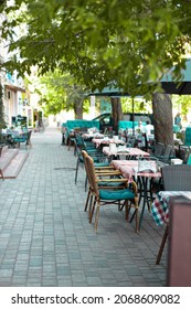 Outdoor Empty Street Restaurant With Wood Stile Chairs. Coronavirus Crisis