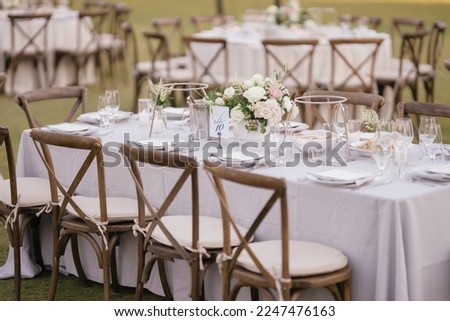 outdoor event, white chairs and tables placed outside ,wedding event, beautiful view outside
