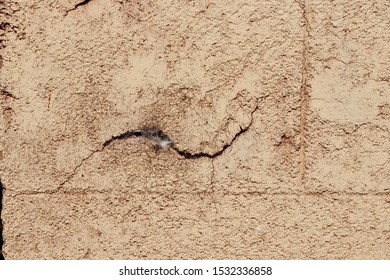 Outdoor exterior building cinderblock cement wall, old dusty cracked stucco surface, grungy background texture