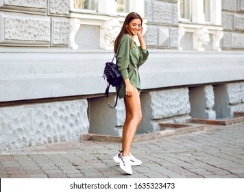 Outdoor Fashion Full Length Image Of Stylish Woman Walking On The Street Wearing Trendy Hipster Swag Minimalistic Outfit, Ugly Sneakers And Small Backpack.