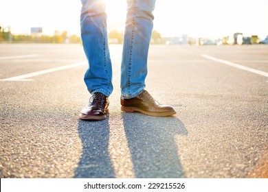 Outdoor Fashion Image Of Man Legs, Wearing Jeans And Stylish Vintage Shoes, Sunny Day, Evening Sunlight.