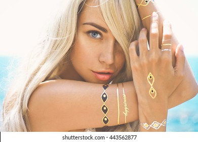Outdoor Fashion Portrait Of Beautiful Blonde Lady At Beach With Flash Tattoo
