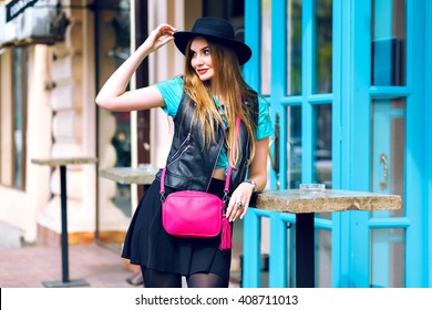 Outdoor Fashion Portrait Of Stylish Sexy Woman Walking Alone, Stylish Outfit, Mini Skirt, Black Hat And Biker Jacket, Bright Fashion Details, Positive Mood, Summertime, Street Style, City Center.