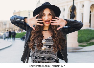 Outdoor Fashion Portrait Of Stylish  Young  Woman Having Fun, Emotional Face , Laughing, Looking At Camera. Urban City Street Style. Black Wool Hat. Spring  Or Fall Outfit. 