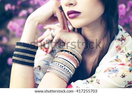 Outdoor fashion portrait of young beautiful woman. Boho chic style, hippie chic vibe outfit, details 