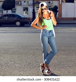 Outdoor Fashion Portrait Of Young Teen Hipster Girl, Street Style Swag Look, Hat, Mom Jeans, Neon Colors, Travel At Europe.
