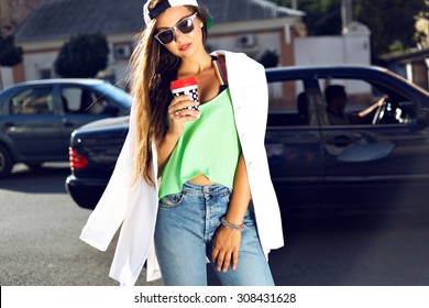 Outdoor Fashion Portrait Of Young Teen Hipster Girl, Street Style Swag Look, Hat, Mom Jeans, Neon Colors, Travel At Europe.