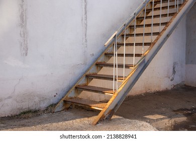 Outdoor Fire Exit Stair Of Old Building. Rusty Fire Escapes Metal Stair.