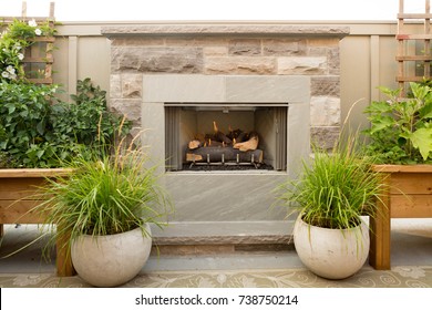 An Outdoor Fireplace On A Patio. 