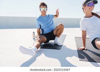 Outdoor Fitness Enthusiasts Practicing Stretching and Core Exercises on Yoga Mats Under Bright Sunlight During a Morning Workout Session - Powered by Shutterstock