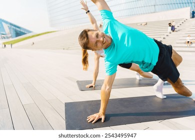 Outdoor Fitness Training Session With Diverse Participants Engaging in Core Exercises at a Modern Urban Location - Powered by Shutterstock