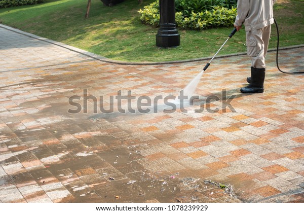 Outdoor floor cleaning with a pressure water jet\
on street