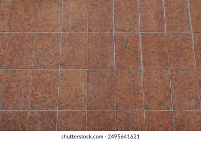 Outdoor floor earthenware tiles with black and red speckles.  Background and texture. - Powered by Shutterstock