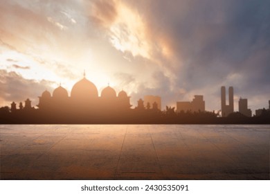 Outdoor floor with a view of a silhouette of the mosque with a dramatic sky view background. Islamic background