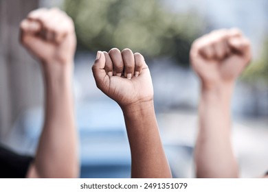 Outdoor, hands and fist in protest for freedom, human rights and equality with community campaign. Diversity, people or protesters with teamwork in strike, raise awareness and advocacy for change - Powered by Shutterstock