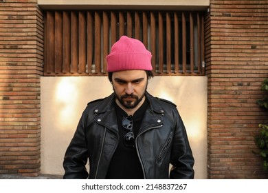 Outdoor Headshot Of Beard Hipster Man Posing In Leather Jacket And Beanie Hat.