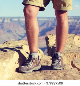 Outdoor Hiking Shoes - Closeup Crop Of Legs Of Male Hiker Walking In Wool Socks And Boots On Summer Nature Trail, Grand Canyon Background. Active Lifestyle Adventure Gear Concept.