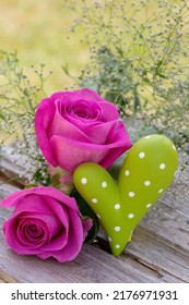 Outdoor Holiday Decoration With Pink Roses And Green Heart