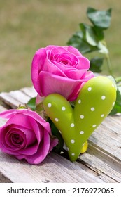 Outdoor Holiday Decoration With Pink Roses And Green Heart