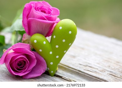 Outdoor Holiday Decoration With Pink Roses And Green Heart