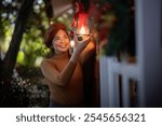 Outdoor Holiday Decorator Illumining Festive Lanterns at Evening Dusk