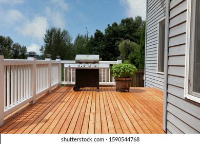 Outdoor Home Deck With Bbq Cooker And Basil Herbs