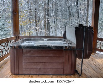 Outdoor Hot Tub On A Cabin Deck During Winter Snow