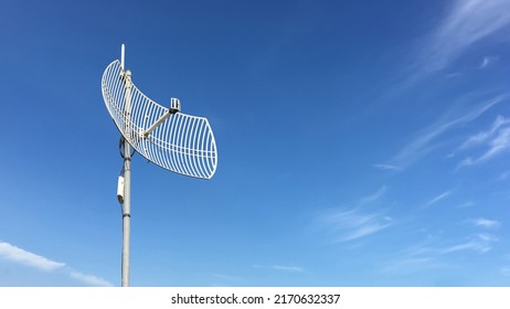 Outdoor Internet Wifi Receiver And Repeater Antenna On The Roof Of The Building With Clear Bluesky Background.