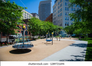 Outdoor Kids Playground Nestled Between Skyscrapers In Boston, Massachusetts. Few Kids Rides Are Visible.