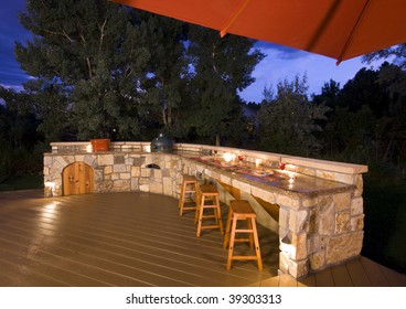 Outdoor Kitchen On Backyard At Dusk