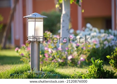 Outdoor lamp on yard lawn for garden lighting in summer park