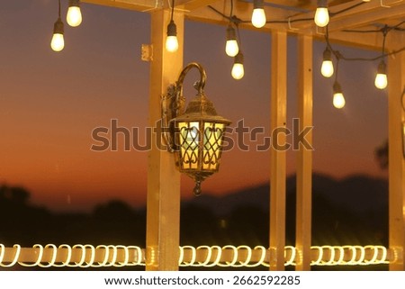 Outdoor Lantern with String Lights at Dusk