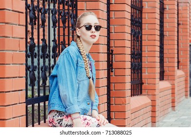 Outdoor Lifestyle Portrait Of Beautiful Young Blonde Girl Posing On The Background Of The City, Dressed In A Preppy Style In Sunglasses.