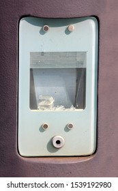 Outdoor Light Mounted On Concrete Pole With Broken Light Bulb Shattered In Pieces At Local Train Station On Warm Sunny Summer Day