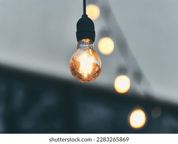 Outdoor lighting fixture featuring a classic bulb hanging from a sleek black cord. Perfect for adding a touch of retro flair to any design. - Powered by Shutterstock