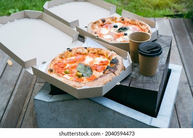 Outdoor Lunch With A Take Away Pizza In A Cardboard And Coffee To Go.