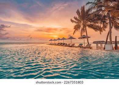 Outdoor luxury sunset over infinity pool swimming summer beachfront hotel resort, tropical landscape. Beautiful tranquil beach holiday vacation background. Amazing island sunset beach view, palm trees