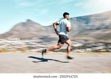 Outdoor, man and running for fitness on road with exercise, training and workout in Brazil. Male person, motion blur and jogging or race for wellness, wellbeing and self care or health as athlete - Powered by Shutterstock