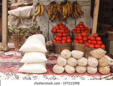 Outdoor Market In Ghana West Africa With Tomatoes, Dried Beans, And Plantains