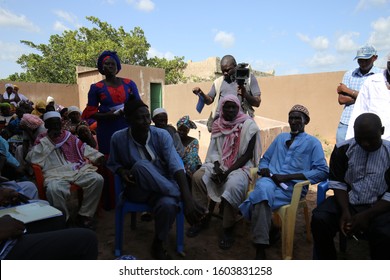 Outdoor Meeting Of People Of Sonankoro Village, Kolda Region, Southern Senegal, West Africa. October, 11, 2019. Group Of African Sitting Persons Speaking Together. Meeting In A Rural Place.