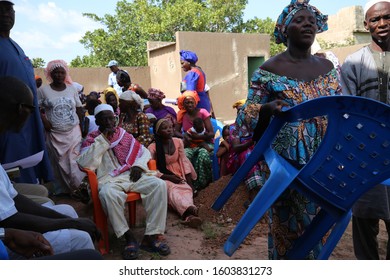 Outdoor Meeting Of People Of Sonankoro Village, Kolda Region, Southern Senegal, West Africa. October, 11, 2019. Group Of African Sitting Persons Speaking Together. Meeting In A Rural Place.