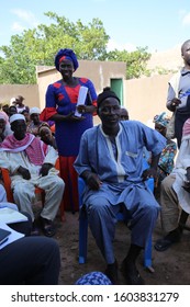 Outdoor Meeting Of People Of Sonankoro Village, Kolda Region, Southern Senegal, West Africa. October, 11, 2019. Group Of African Sitting Persons Speaking Together. Meeting In A Rural Place.