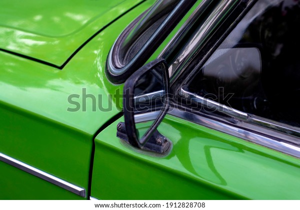 Outdoor\
mirror of old Soviet car. Side view. View from the front. The body\
is green. Kurskoe, Crimea - 4 October,\
2020