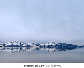 Outdoor Nature Amazing Snow Mountain Reflection In Water In Lake Tahoe While Family Trip In Vacation