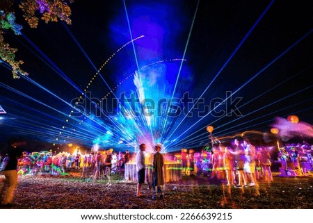 Outdoor night music party with laser lights and fire summer